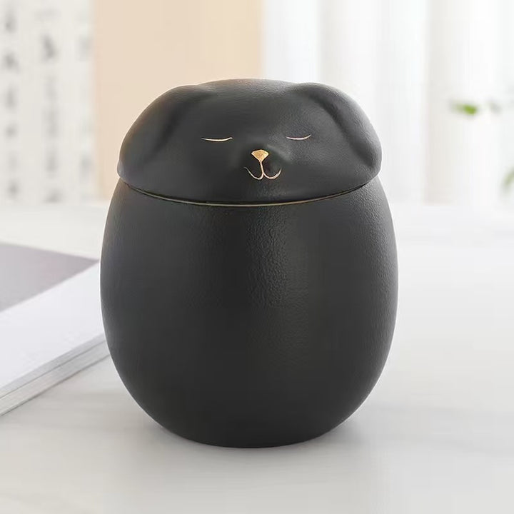 Black ceramic urn shaped like a dog.