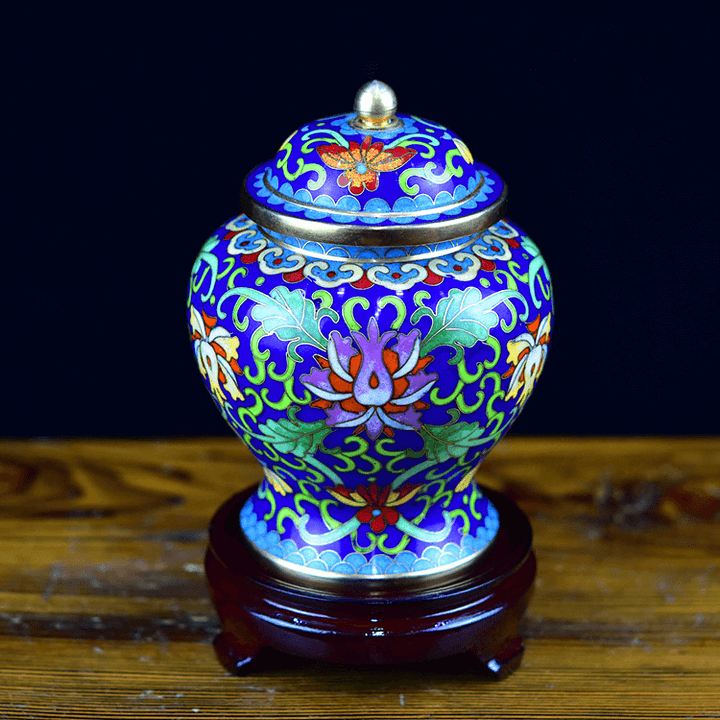 Colorful ceramic jar with intricate patterns on a wooden stand against a dark background