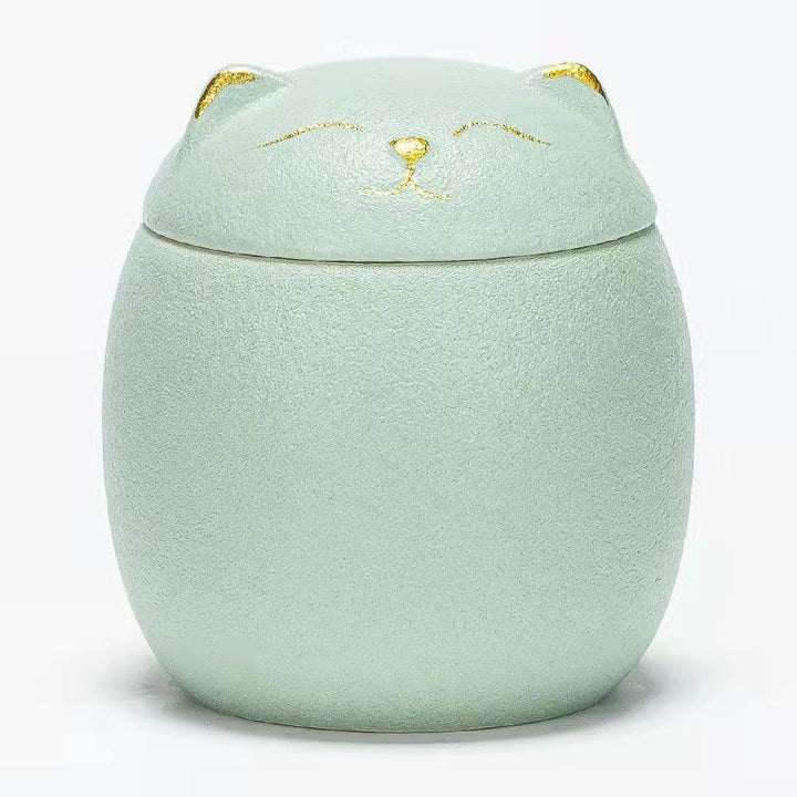 Mint green cat-shaped container with a lid on a white background