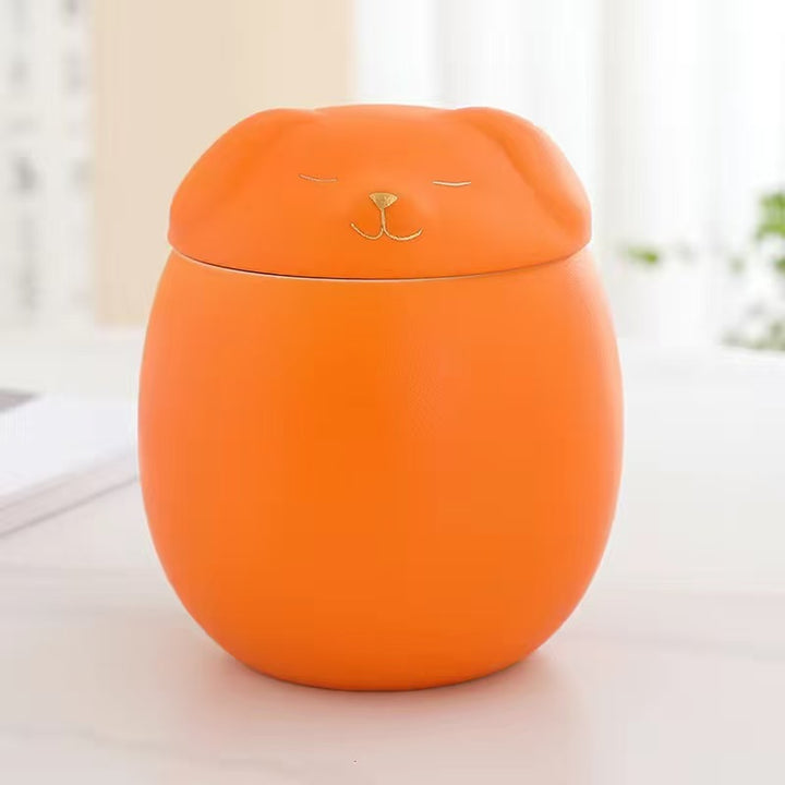 Orange container with a cat face design on a light background