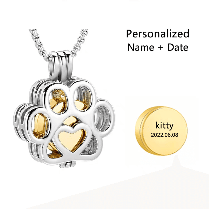 Paw-shaped cremation pendant with gold heart