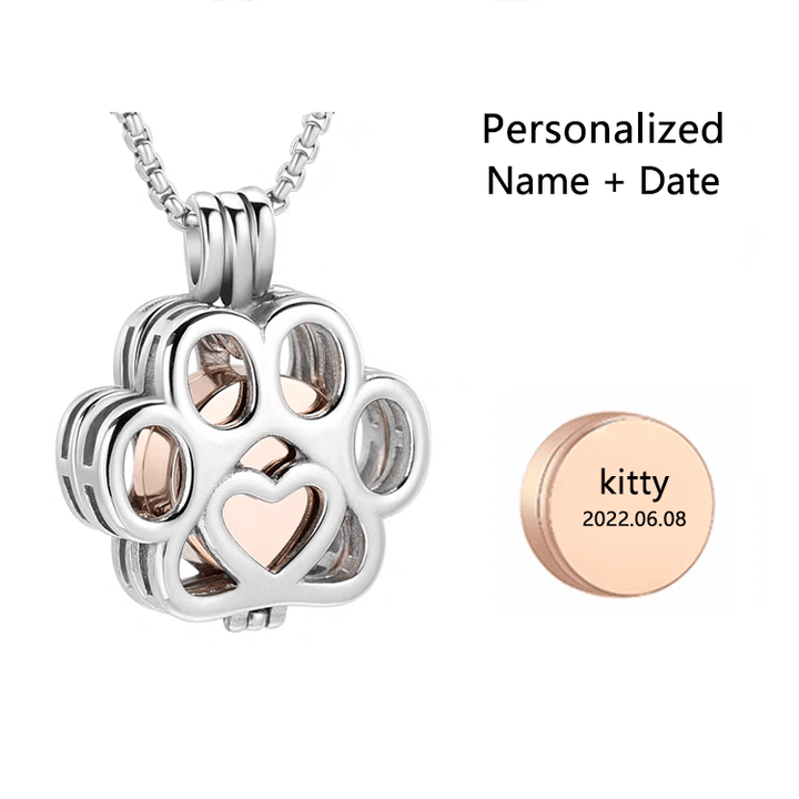 Paw-shaped cremation keepsake pendant with rose gold accents and a personalized round tag 